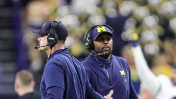 Michigan coach Jim Harbaugh high-fives offensive coordinator Sherrone Moore after a play during the second half of U-M's 26-0 win over Iowa in the Big Ten championship game in Indianapolis on Saturday, Dec. 2, 2023.