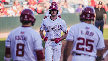 Brent Iredale with Cam Kozeal and Kuhio Aloy after hitting his seventh home run of the year against the Central Arkansas Bears. The Razorbacks won 9-2.