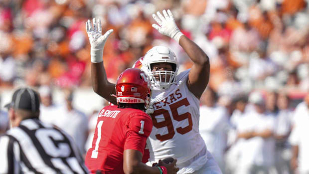 Texas Longhorns defensive lineman Alfred Collins blocks a pass against the Houston Cougars