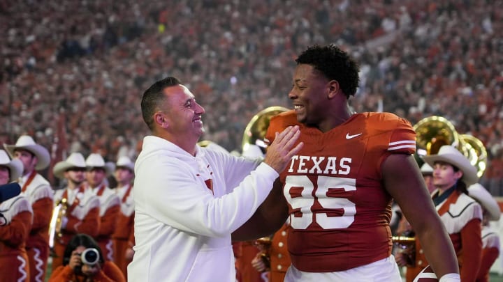 Texas Longhorns head coach Steve Sarkisian congratulated Texas Longhorns defensive lineman Alfred Collins (95) on senior night before the game against Texas Tech at Darrell K Royal Texas Memorial Stadium on Friday, Nov. 24, 2023.