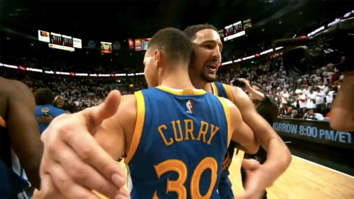Klay Thompson and Steph Curry embrace after a win.
