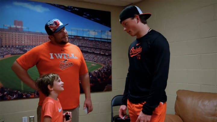 Jackson Holliday meets a young fan after hitting his first career home run Wednesday against the Blue Jays.