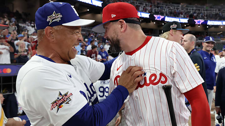 Dave Roberts congratulates Kyle Schwarber after the National League defeated the American League to win the MLB All-Star Game at Truist Park.