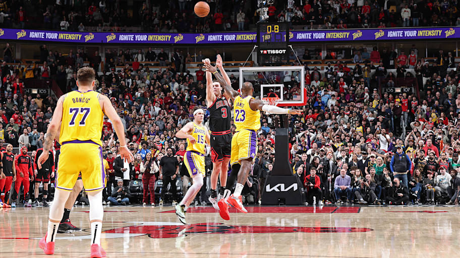 Josh Giddey nails a half-court shot in the Bulls' 119-117 win over the Lakers on March 27. | Jeff Haynes/NBAE