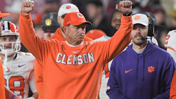 Nov 25, 2023; Columbia, South Carolina, USA; Clemson Tigers head coach Dabo Swinney celebrates with offensive coordinator Garrett Riley as time expires against the South Carolina Gamecocks at Williams-Brice Stadium.  Clemson won 16-7. Mandatory Credit: Ken Ruinard-Imagn Images