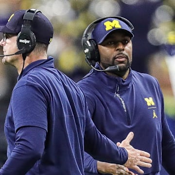 Michigan coach Jim Harbaugh high-fives offensive coordinator Sherrone Moore after a play during the second half of U-M's 26-0 win over Iowa in the Big Ten championship game in Indianapolis on Saturday, Dec. 2, 2023.