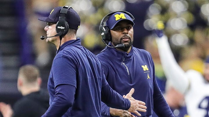Michigan coach Jim Harbaugh high-fives offensive coordinator Sherrone Moore after a play during the second half of U-M's 26-0 win over Iowa in the Big Ten championship game in Indianapolis on Saturday, Dec. 2, 2023.