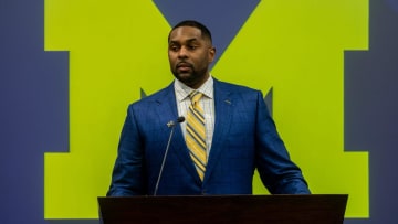 Sherrone Moore, Michigan's new head football coach, speaks in front of family, media, and faculty members.