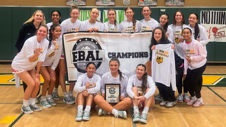 San Ramon Valley's girls basketball team poses after winning their fourth straight EBAL title with a 70-49 home win over Carondelet