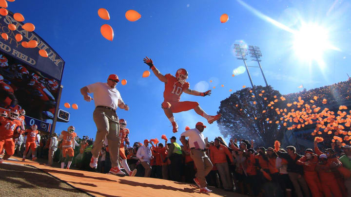 Clemson's Ben Boulware jumps while others run down the hill before kickoff with USC November 29, 2014.