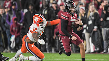 Nov 25, 2023; Columbia, South Carolina, USA; South Carolina Gamecocks quarterback Spencer Rattler (7) runs the ball against Clemson Tigers defensive lineman T.J. Parker (12) during the first quarter at Williams-Brice Stadium. Mandatory Credit: Ken Ruinard-Imagn Images