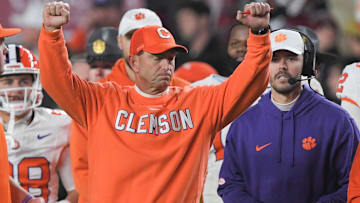 Nov 25, 2023; Columbia, South Carolina, USA; Clemson Tigers head coach Dabo Swinney celebrates with offensive coordinator Garrett Riley as time expires against the South Carolina Gamecocks at Williams-Brice Stadium.  Clemson won 16-7. Mandatory Credit: Ken Ruinard-Imagn Images
