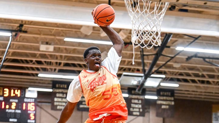 Team Faygo and Michigan State's Coen Carr, top, jumps over Team Case Credit Union's Colin Jones for a dunk in the game on Thursday, June 27, 2024, during the Moneyball Pro-Am at Holt High School.