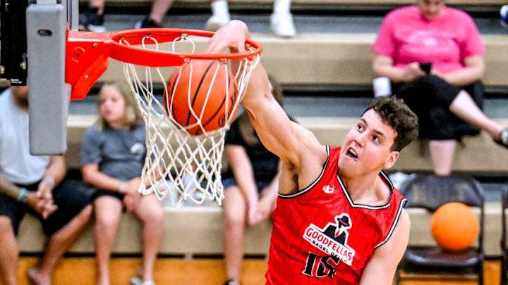 Team Goodfellas' Team Goodfellas' and Michigan State's Szymon Zapala dunks against Team Tri-Star Trust in the game on Tuesday, July 16, 2024, during the Moneyball Pro-Am at Holt High School.