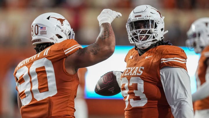 Texas Longhorns defensive lineman T'Vondre Sweat (93) and Texas Longhorns defensive lineman Byron Murphy II (90) celebrate a play during the game against Texas Tech at Darrell K Royal Texas Memorial Stadium on Friday, Nov. 24, 2023.