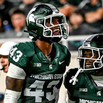 Michigan State's Malik Spencer, left, celebrates a stop with Charles Brantley during the first quarter in the game against Ohio State on Saturday, Sept. 28, 2024, at Spartan Stadium in East Lansing.