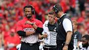 Cincinnati Bearcats defensive coordinator Marcus Freeman, left, stands next to head coach Luke Fickell during an injury timeout of a college football game against the Ohio State Buckeyes, Saturday, Sept. 7, 2019, at Ohio Stadium in Columbus