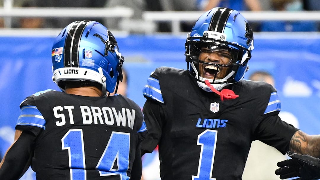Detroit Lions wide receiver Amon-Ra St. Brown (14) celebrates a touchdown with wide receiver Jameson Williams (1) 