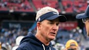 Tennessee Titans interim coach Mike McCoy greets Los Angeles Chargers coach Jim Harbaugh.