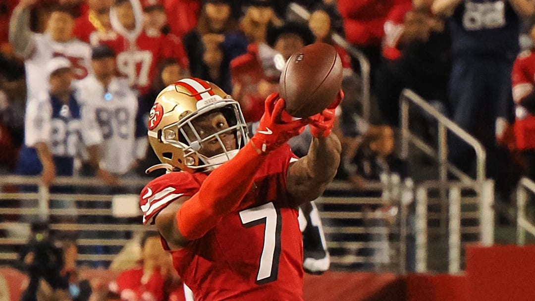 San Francisco 49ers cornerback Charvarius Ward attempts to gather the ball on a Dallas Cowboys pass.