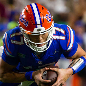 Florida Gators quarterback Max Brown (17) eludes a Seminole defender at Steve Spurrier Field at Ben Hill Griffin Stadium in Gainesville, FL on Saturday, November 25, 2023 during the second half. Florida State won 24-15. [Doug Engle/Gainesville Sun]