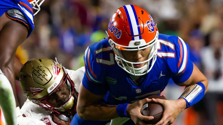 Florida Gators quarterback Max Brown (17) eludes a Seminole defender at Steve Spurrier Field at Ben Hill Griffin Stadium in Gainesville, FL on Saturday, November 25, 2023 during the second half. Florida State won 24-15. [Doug Engle/Gainesville Sun]