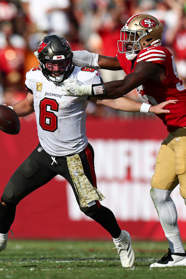Buccaneers quarterback Baker Mayfield is pressured by 49ers defensive end Leonard Floyd. 