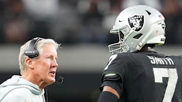 Nov 23, 2025; Paradise, Nevada, USA; Las Vegas Raiders quarterback Geno Smith (7) talks to head coach Pete Carroll in game against the Cleveland Browns during the fourth quarter at Allegiant Stadium. Mandatory Credit: Stephen R. Sylvanie-Imagn Images