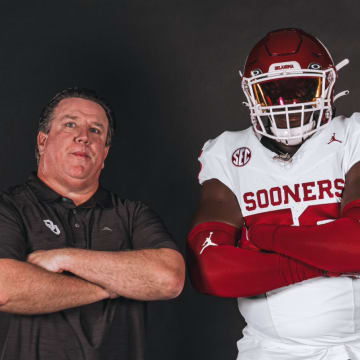 Oklahoma offensive lineman Michael Fasusi and offensive line coach Bill Bedenbaugh