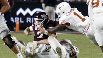 Oct 25, 2025; Starkville, Mississippi, USA; Texas Longhorns defensive linemen Ethan Burke (91) and Texas Longhorns defensive linemen Colin Simmons (1) force Mississippi State Bulldogs quarterback Blake Shapen (2) to fumble during overtime at Davis Wade Stadium at Scott Field. Mandatory Credit: Petre Thomas-Imagn Images