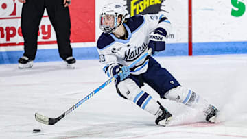 Sophomore Oskar Komarov skates with the puck