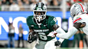 Michigan State's Nick Marsh, left, runs after a catch as Ohio State's Denzel Burke closes in during the second quarter on Saturday, Sept. 28, 2024, at Spartan Stadium in East Lansing.