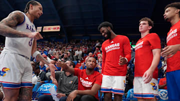 Kansas Jayhawks players slap hands with Kansas Jayhawks guard Tre White (3) as he returns back to the bench during the second half of the exhibition game against Fort Hays State Tigers inside Allen Fieldhouse on Tuesday, October, 28, 2025.