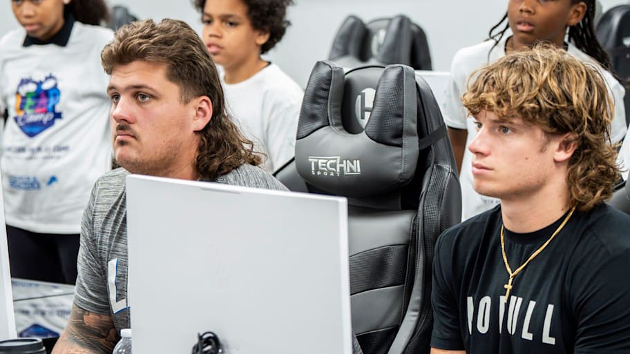 Detroit Lions rookie offensive lineman Tate Ratledge and rookie wide receiver Isaac TeSlaa listen to a speaker | Ryan Garza / USA TODAY NETWORK via Imagn Images