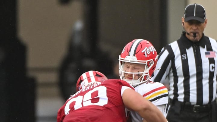 Sep 28, 2024; Bloomington, Indiana, USA;  Indiana Hoosiers defensive lineman James Carpenter (99) sacks Maryland Terrapins quarterback Billy Edwards Jr. (9) during the first half at Memorial Stadium. Mandatory Credit: Robert Goddin-Imagn Images