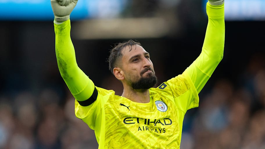 Gianluigi Donnarumma with raised arms and clenched fists.