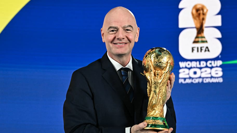 Gianni Infantino holding the World Cup trophy.