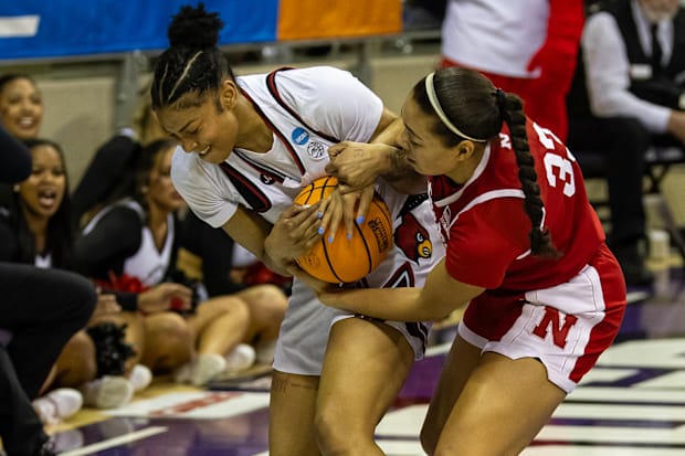 Nebraska forward Amiah Hargrove (right) fights for the ball against Louisville in the first round of the NCAA Tournament.