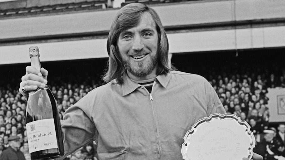 Billy Bonds posing with champane and a trophy.