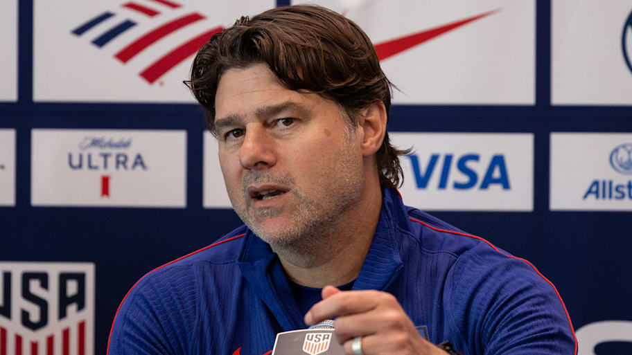 Mauricio Pochettino in front of a microphone.