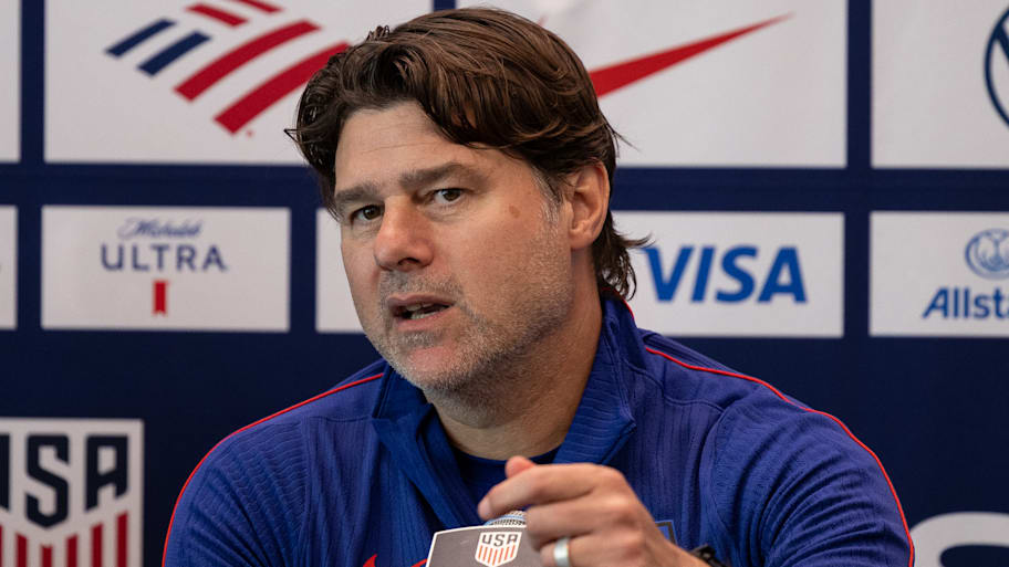 Mauricio Pochettino in front of a microphone.
