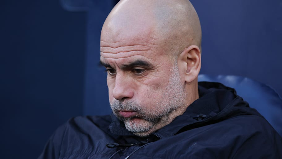 Pep Guardiola puffing out his cheeks.