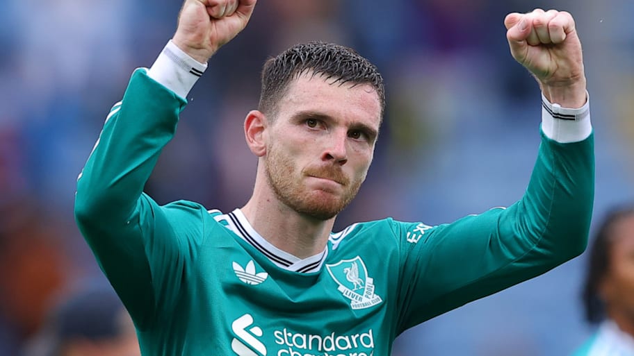 Andy Robertson with his arms raised aloft.