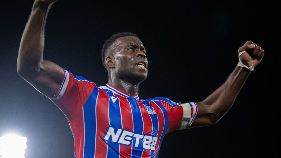 Marc Guéhi with arms raised aloft.