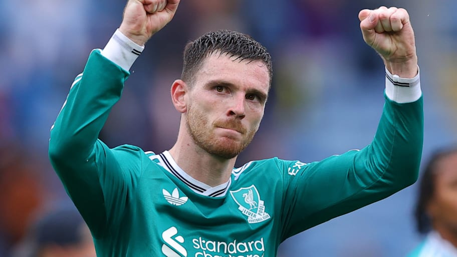 Andy Robertson with his arms raised aloft.