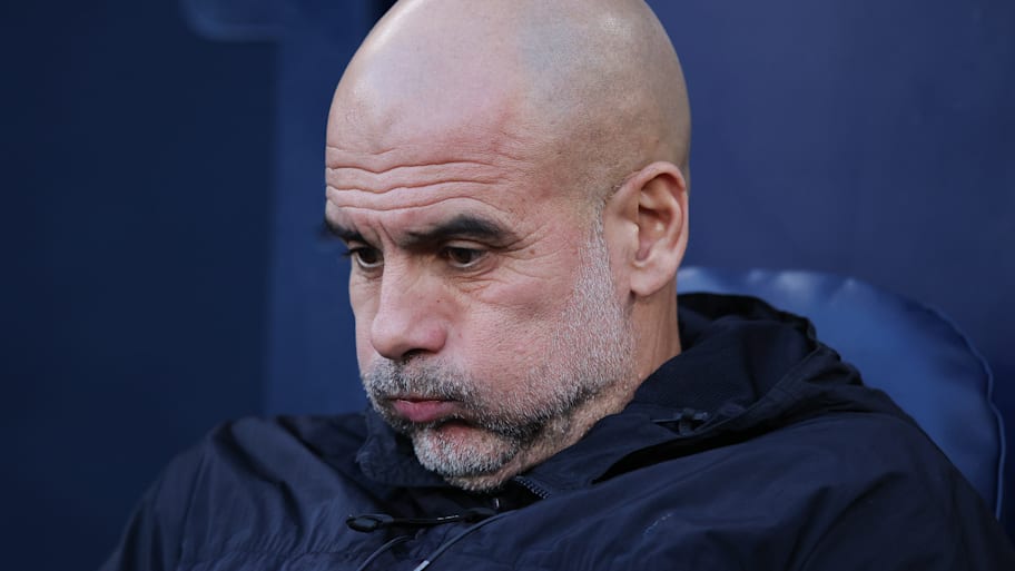 Pep Guardiola puffing out his cheeks.