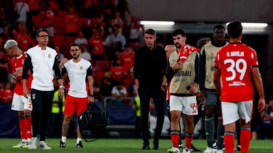Benfica’s manager and players looking disheartened.