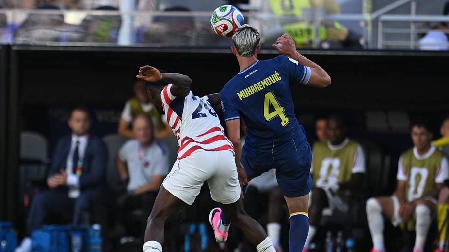 Folarin Balogun (left) crunching into Tarik Muharemović.