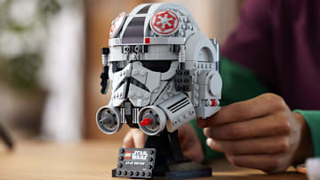 LEGO Star Wars Helmets Collection: the AT-AT Driver Helmet which is gray, white, black, and red. Image Credit: StarWars.com