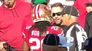 Kliff Kingsbury and Josh Norman trash talk with each other.